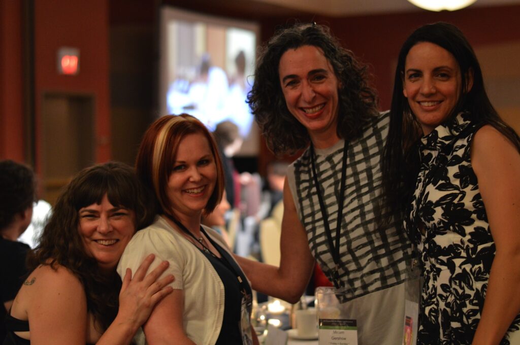 4 writers smiling at the Conference