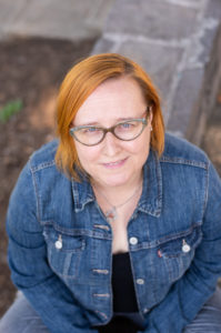 Photo of Author Kelly Garrett looking up at the camera